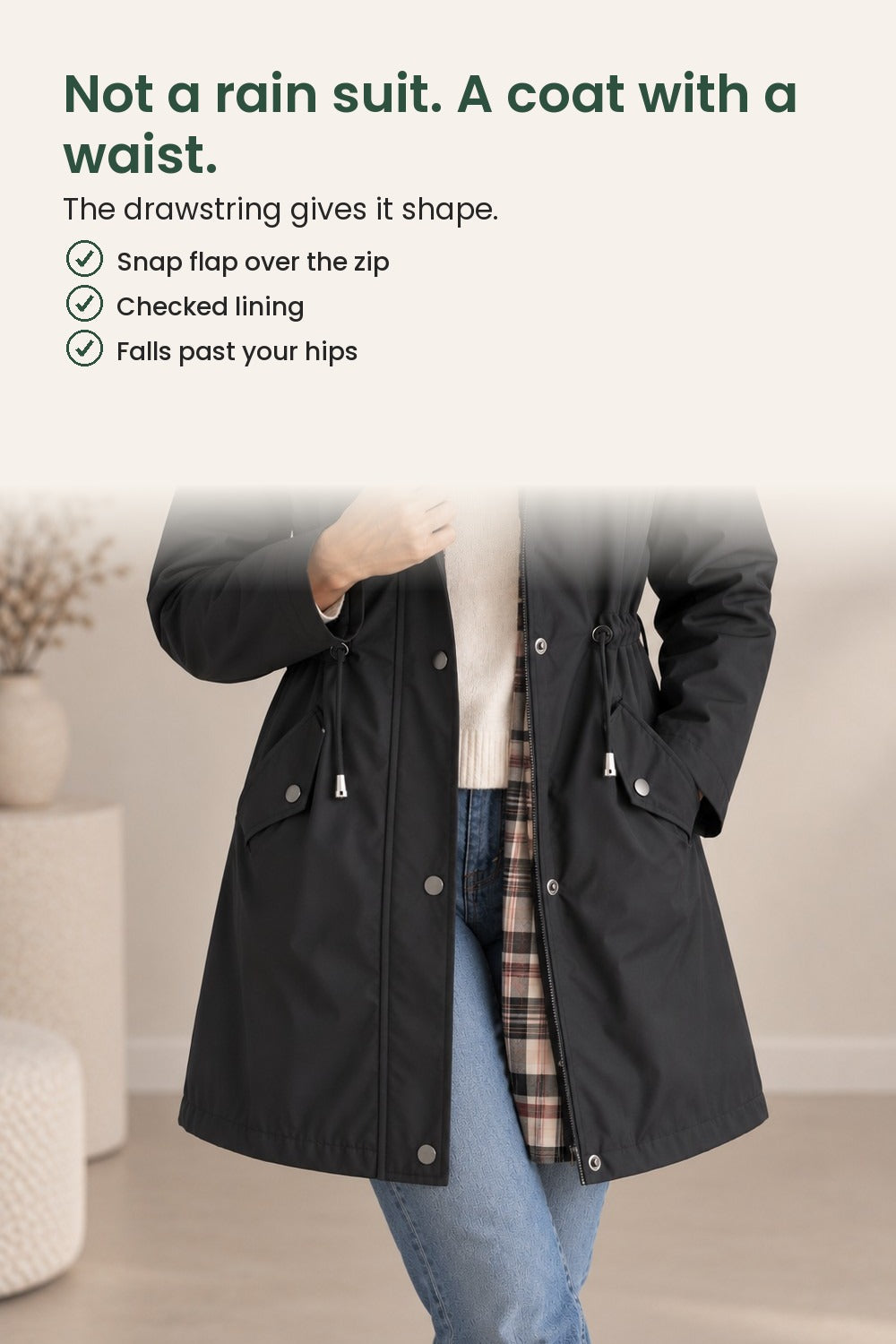 Mid-length coat with hood and press studs – not a rain suit. A coat with a waist. The drawstring gives it shape